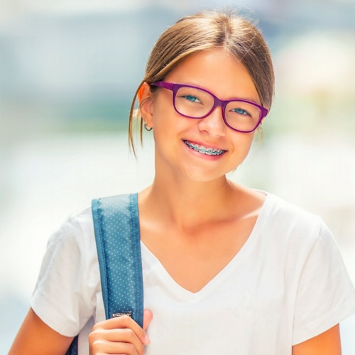 Dental professional inspecting a little firls mouth
